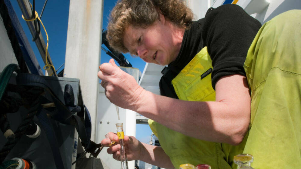 Kim currie taking water samples